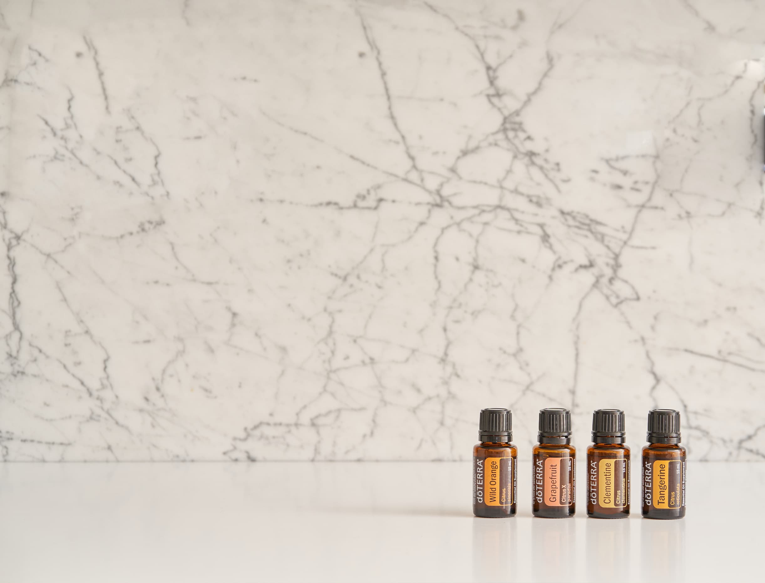 Флаконы эфирных масел doTERRA на светлом камне